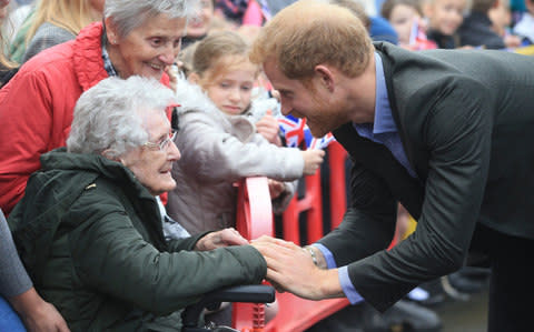 Prince Harry meeting 99 year old Winnie Hodson as he arrives for his visit to the village hall at St Michael's on Wyre in Lancashire - Credit: Danny Lawson/PA Wire