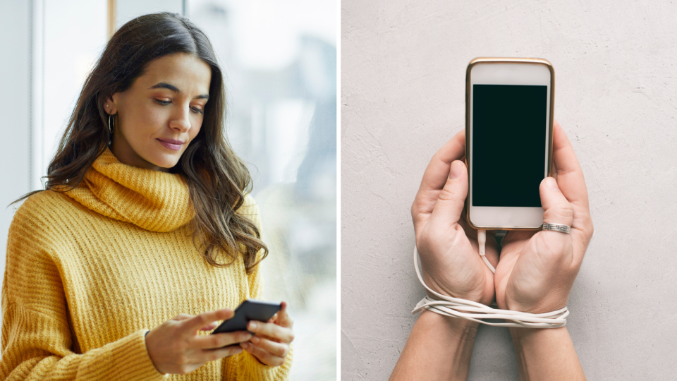 Woman in yellow jumper looks at phone, hands hold phone with cable tied around wrists.