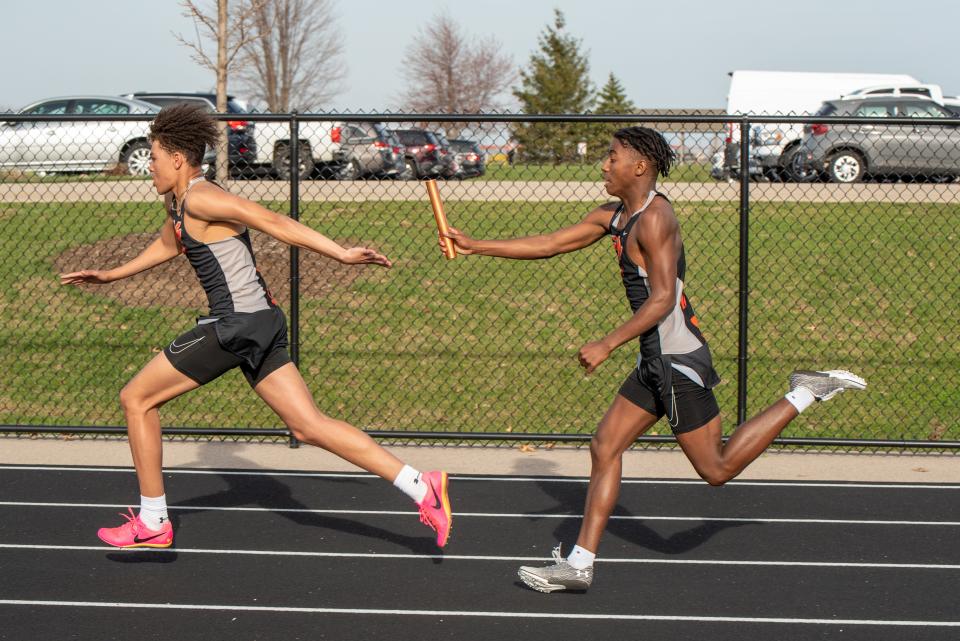 Winnebago relay runner, Blaze Brown, right, hands off to Myles Smith during a recent outdoor track and field meet in Winnebago.