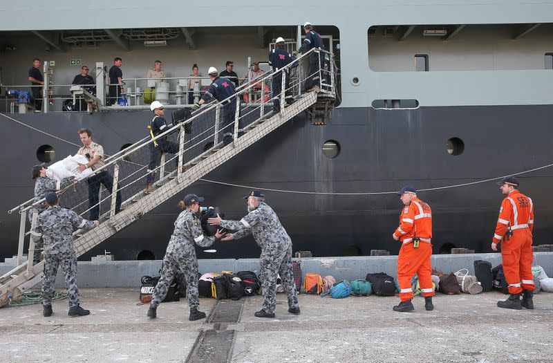 Evacuees arrive from Mallacoota on the navy ship MV Sycamore at the port of Hastings, Victoria, Australia