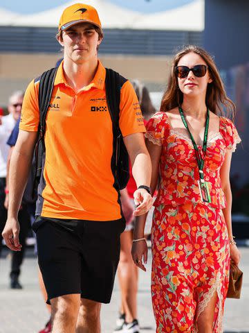 <p>Kym Illman/Getty </p> Oscar Piastri and Lily Zneimer enter the paddock together during the F1 Grand Prix of Abu Dhabi on November 26, 2023.