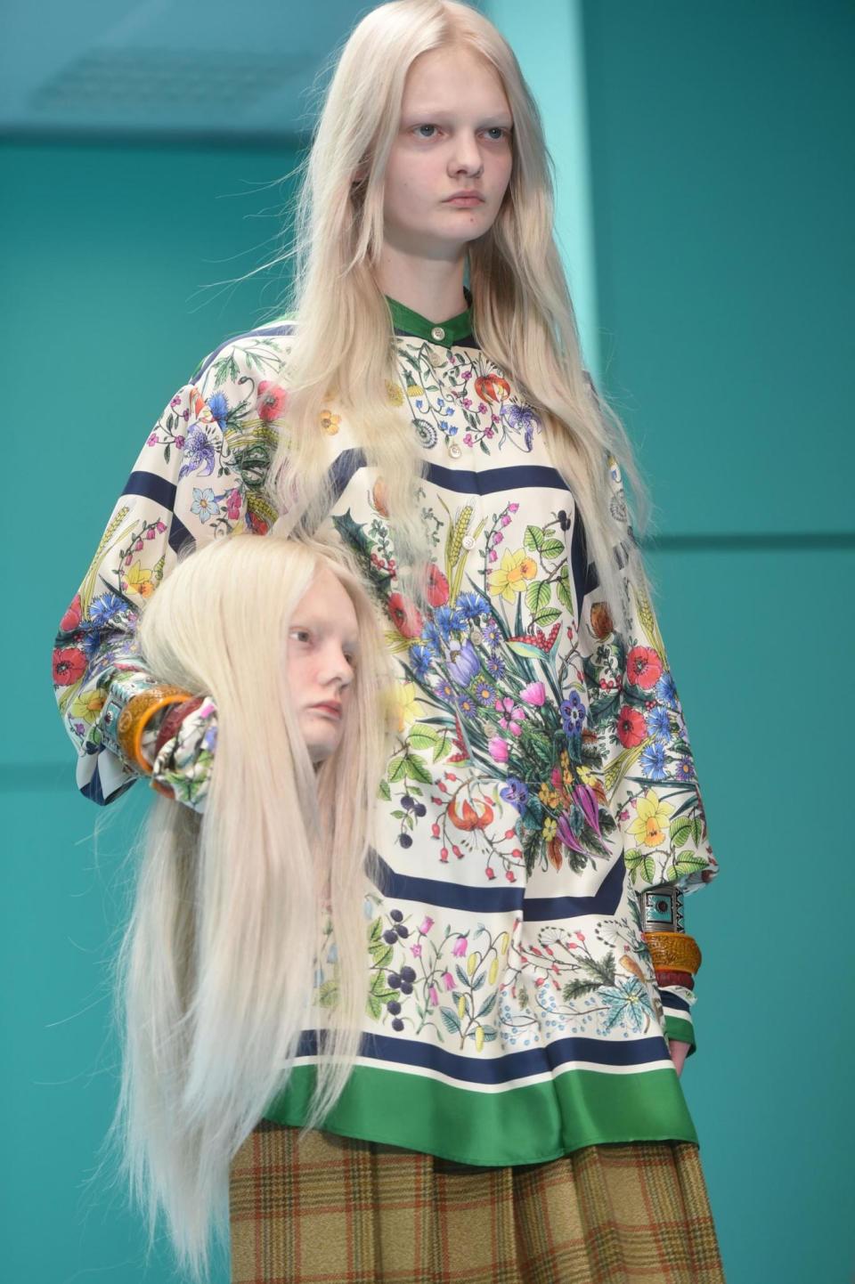 A model carries a severed head down the runway (AFP/Getty Images)