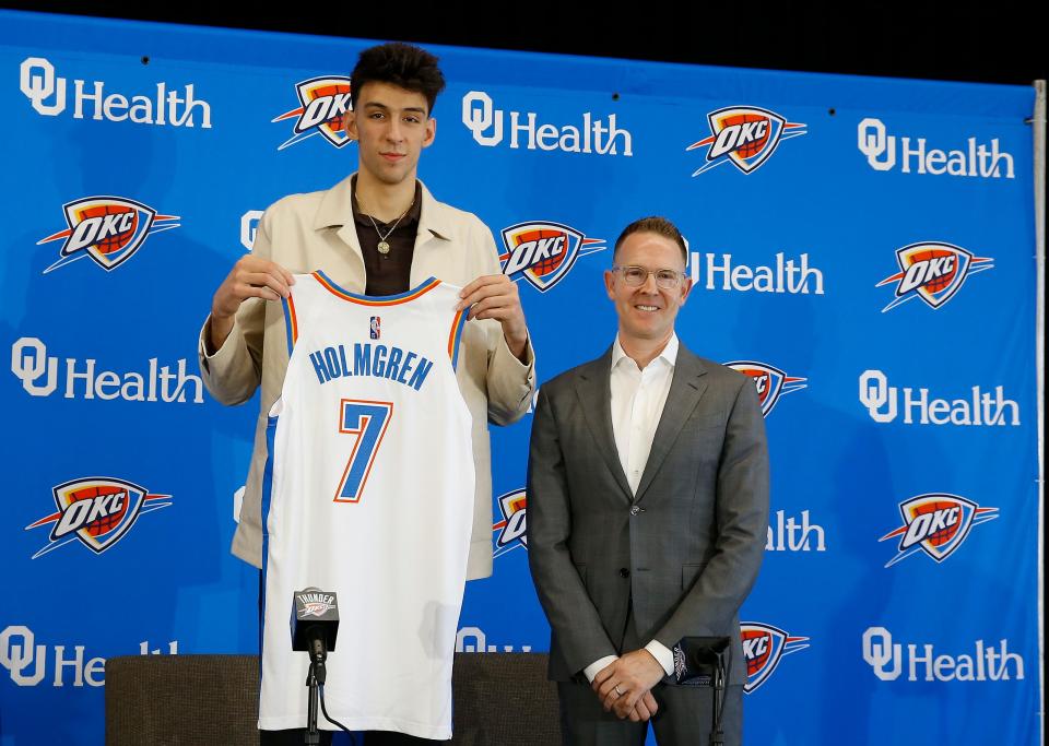 Oklahoma City Thunder forward Chet Holmgren poses with his jersey and general manager Sam Presti following an introductory press conference on June 25.
