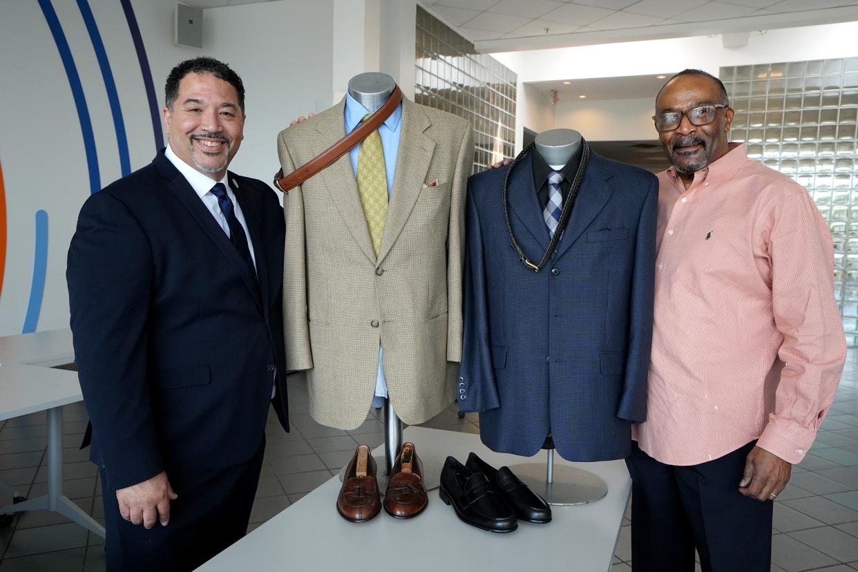 Impact Community Action CEO Robert "Bo" Chilton, left, and Nehemiah House of Refuge Executive Director Terry Byrd, right, pose with professional menswear Thursday at the Otto Beatty Jr. Men's Shop. The Franklin County Board of Commissioners unanimously approved Tuesday giving $330,766 in federal COVID relief funds to the shop, which provides low-income men with a professional wardrobe and other services. The longtime state lawmaker, attorney for Impact and late husband of U.S. Rep. Joyce Beatty donated a sizeable amount of his professional wardrobe.