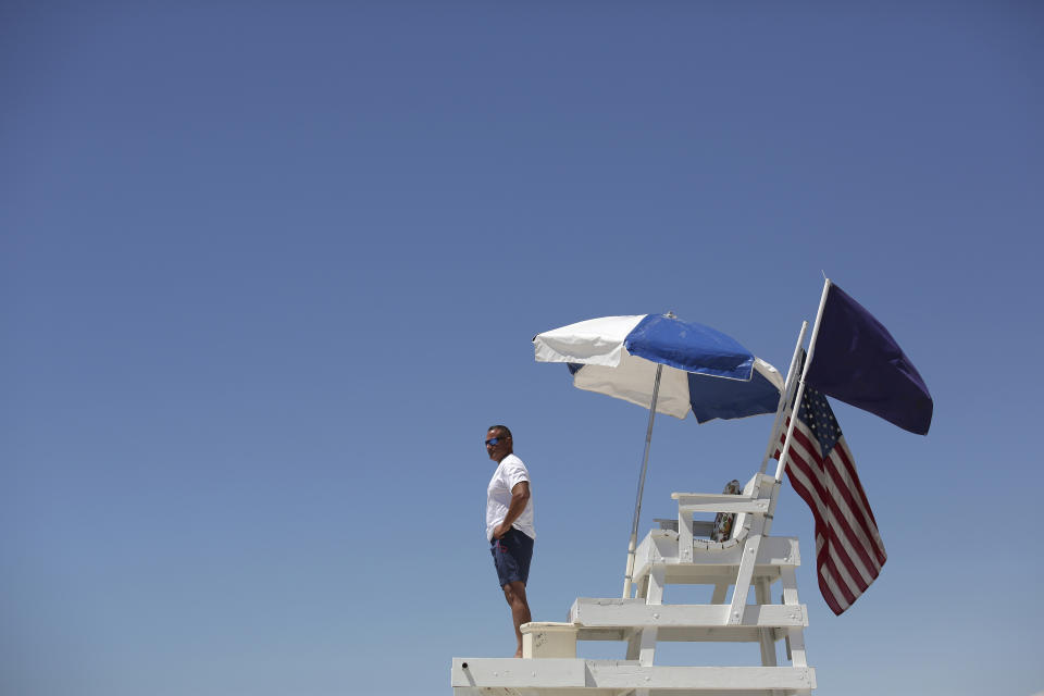 A life guard keeps an eye on the water at Atlantique Beach on Fire Island in Islip, N.Y. Source: AP