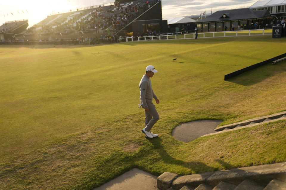 Collin Morikawa of the US walks off the 18th green after his second round of the British Open golf championship on the Old Course at St. Andrews, Scotland, Friday July 15, 2022. The Open Championship returns to the home of golf on July 14-17, 2022, to celebrate the 150th edition of the sport's oldest championship, which dates to 1860 and was first played at St. Andrews in 1873. (AP Photo/Gerald Herbert)