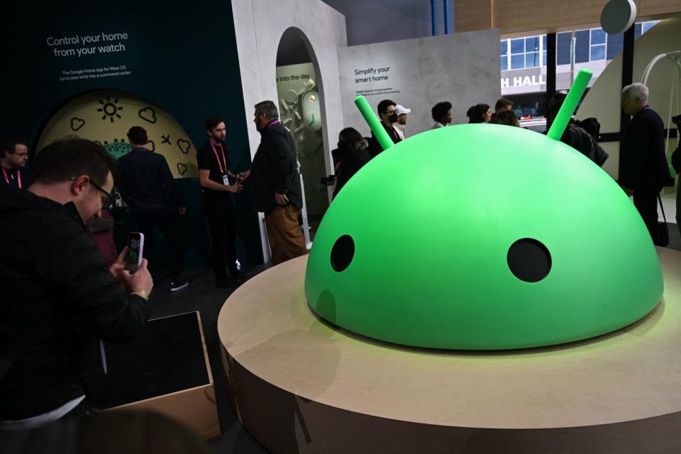 Attendees take pictures of a large Android logo head at Alphabets Google Android plaza booth during the Consumer Electronics Show (CES) in Las Vegas, Nevada on January 5, 2023. (Photo by Patrick T. Fallon / AFP) (Photo by PATRICK T. FALLON/AFP via Getty Images)