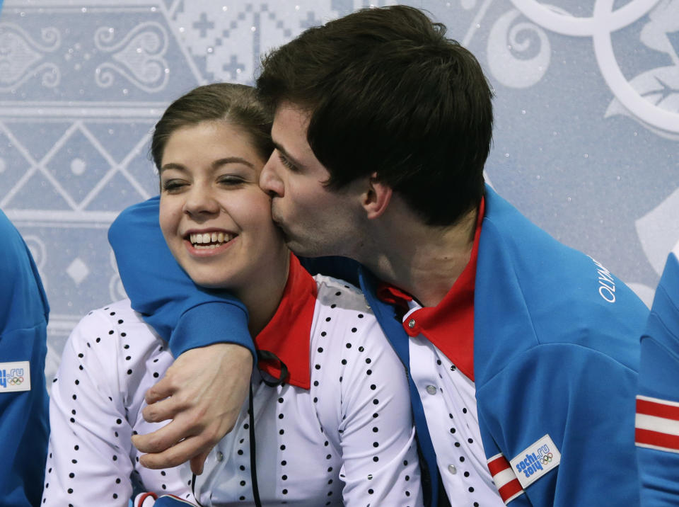 Miriam Ziegler is kissed by Severin Kiefer of Austria as they wait in the results area after competing in the pairs short program figure skating competition at the Iceberg Skating Palace during the 2014 Winter Olympics, Tuesday, Feb. 11, 2014, in Sochi, Russia. (AP Photo/Darron Cummings)