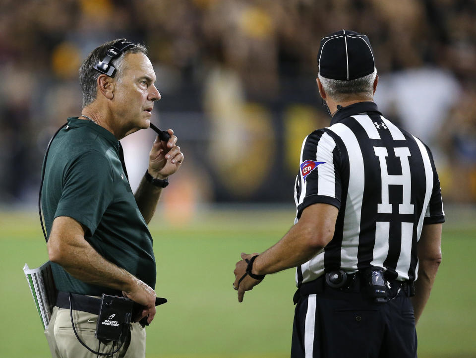 Michigan State head coach Mark Dantonio, left, calls a timeout as he talks with an official during the second half of an NCAA college football game against Arizona State Saturday, Sept. 8, 2018, in Tempe, Ariz. Arizona State defeated Michigan State 16-13. (AP Photo/Ross D. Franklin)