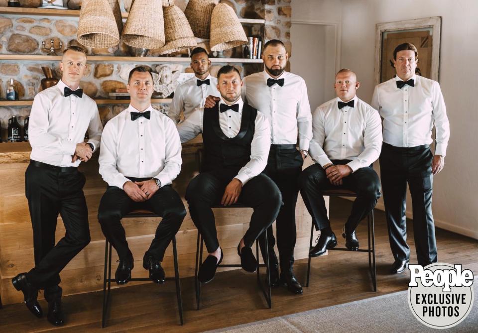 Tebow's groomsmen matched his classic tux look, wearing black suits by <a href="https://www.indochino.com/" rel="nofollow noopener" target="_blank" data-ylk="slk:Indochino;elm:context_link;itc:0;sec:content-canvas" class="link ">Indochino</a> with white shirts and bowties.