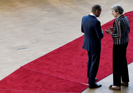 European Council President Donald Tusk and Britain's Prime Minister Theresa May talk as they arrive for a group photo at the ASEM leaders summit in Brussels, Belgium October 19, 2018. REUTERS/Piroschka van de Wouw/Files