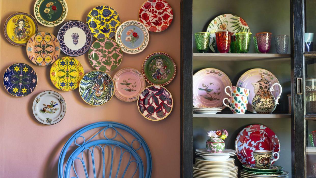 a wall with plates and vases