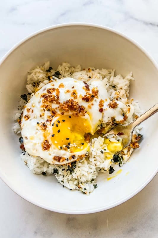 <p>This Healthy Table</p><p>This easy recipe for chili crisp oil eggs can be served over rice for a delicious breakfast or lunch. </p><p><strong>Get the recipe here: <a href="https://thishealthytable.com/blog/chili-oil-eggs/" rel="nofollow noopener" target="_blank" data-ylk="slk:Chili Crisp Eggs;elm:context_link;itc:0;sec:content-canvas" class="link ">Chili Crisp Eggs</a></strong></p>