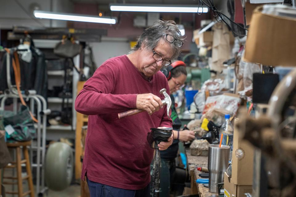 Terry and Maggie Luneke work on shoes at Terry's Shoe Repair in the Plaza La Mer shopping center in Juno Beach, Florida on October 25, 2023.