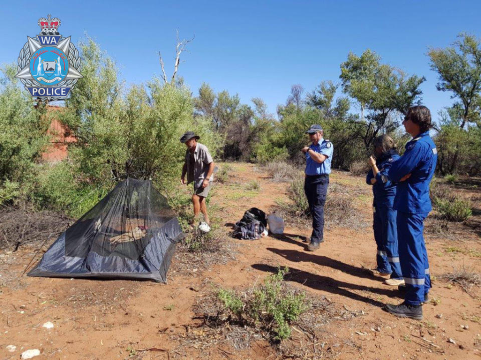 Pilbara man Phillip Blampied and his rescuers pictured at his makeshift campsite in Western Australia.