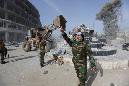 Turkish-backed Free Syrian Army members pull down Kurdish statue in the center of Afrin, Syria March 18, 2018. REUTERS/Khalil Ashawi