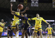 Baylor guard Moon Ursin, left, battles West Virginia guard Jayla Hemingway for the ball with teammate Trinity Oliver, right, looking on in the second half of an NCAA college basketball game, Monday, March 8, 2021, in Waco, Texas. (Rod Aydelotte/Waco Tribune Herald, via AP)