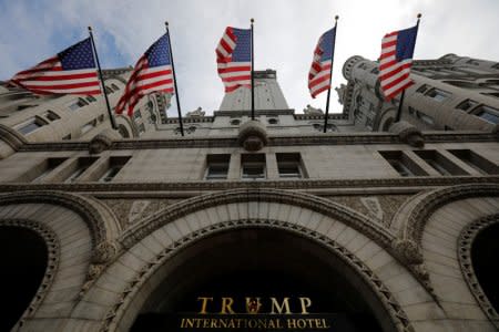 FILE PHOTO: U.S. flags fly over the Trump International Hotel in Washington, U.S., August 3, 2018.     REUTERS/Brian Snyder