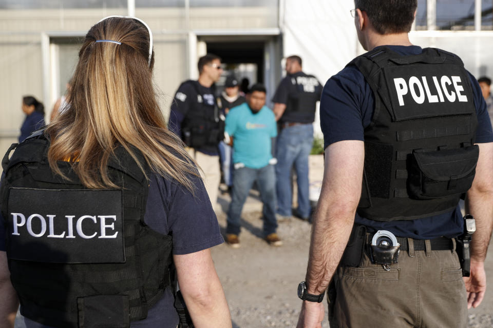 Government agents detain people during an immigration raid in Castalia, Ohio, on June 5. Regular raids are a key part of the Trump administration's crackdown on undocumented immigrants. (Photo: John Minchillo/ASSOCIATED PRESS)