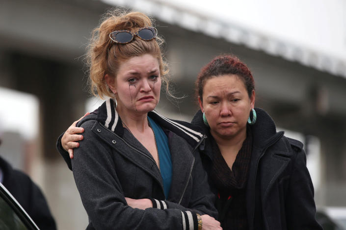 <p>Twiggy Damy (R) hugs an unidentified mourner at a sidewalk memorial near the burned warehouse following the fatal fire in the Fruitvale district of Oakland, Calif., on Dec. 5, 2016. (Lucy Nicholson/Reuters) </p>