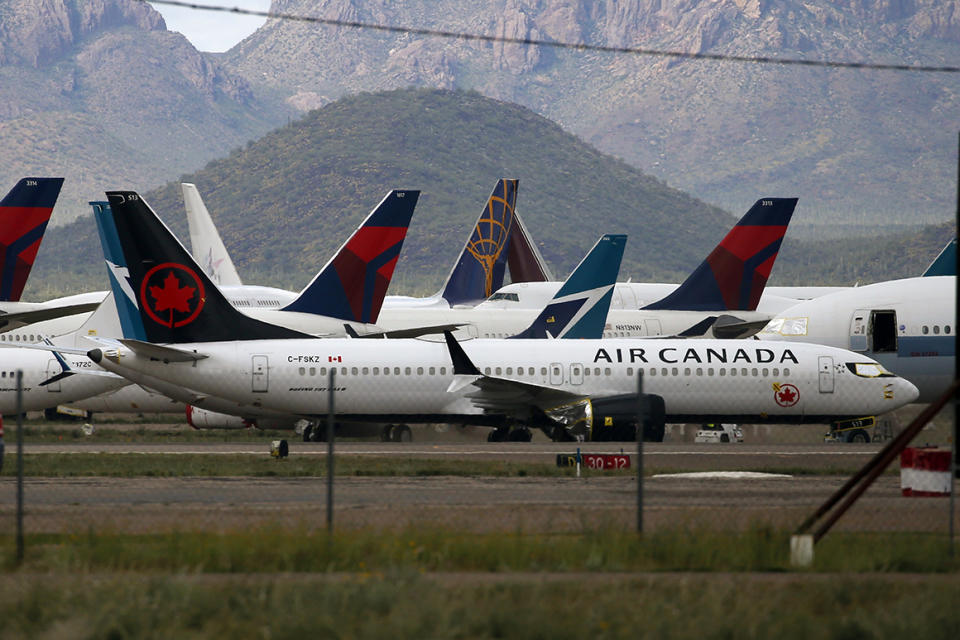 Planes are parked at Pinal Airpark on Wednesday in Red Rock, Ariz., as many passenger planes are being kept at the facility as airlines cut back on service due to the new coronavirus pandemic.