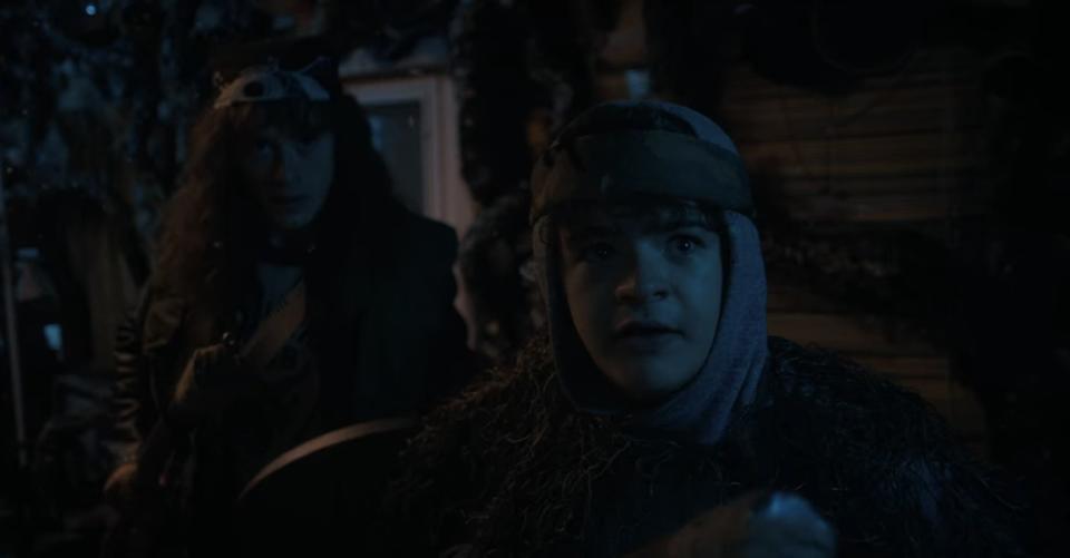 Dustin and Eddie, armed with weapons, inside the latter's trailer in the Upside Down in "Stranger Things"