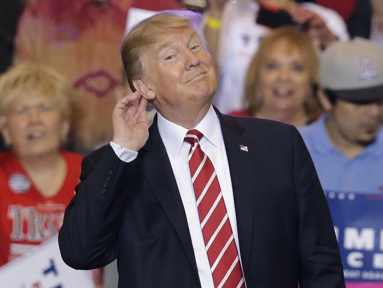 Mr Trump revved up supporters at the Phoenix Convention Center with a defence of his response to a white supremacist-organised rally in Virginia: AP/Rick Scuter