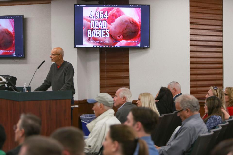 An image claiming vaccines injure children is shown during a Collier County commission meeting at the Collier County administration building in Naples on Tuesday, Feb. 14, 2023. Multiple speakers asked the board to return money from the COVID-19 Extra Mile Migrant Farmworker Community Grant. The board voted unanimously to return it.