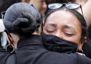 Women hug as people gather at the Alexander Platz in Berlin, Germany, Saturday, June 6, 2020, to protest against the recent killing of George Floyd by police officers in Minneapolis, USA, that has led to protests in many countries and across the US. A US police officer has been charged with the death of George Floyd. (AP Photo/Markus Schreiber)