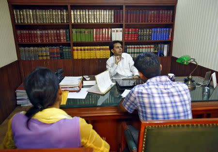 Rahul Tyagi (C), the lawyer of Meenakshi Kumari (L), one of the two sisters allegedly threatened with rape by a village council in Uttar Pradesh, and her brother sit inside Tyagi's chamber in New Delhi, India, September 1, 2015. REUTERS/Anindito Mukherjee