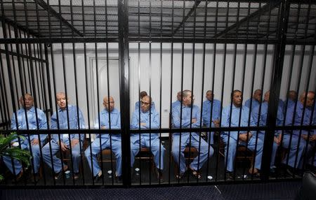 Former Gaddafi regime's officials sit behind bars during a verdict hearing at a courtroom in Tripoli, Libya July 28, 2015. REUTERS/Ismail Zitouny