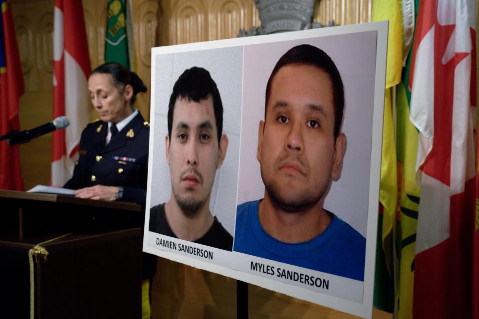 Assistant Commissioner Rhonda Blackmore speaks next to images of Damien Sanderson and Myles Sanderson during a press conference at the Royal Canadian Mounted Police "F" Division headquarters in Regina, Saskatchewan, on Sunday, Sept. 4, 2022.