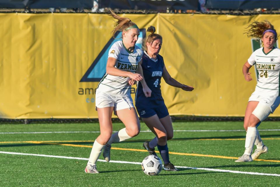 New Hampshire's Logan Nicholson challenges for possession against Vermont in the America East women's soccer tournament.