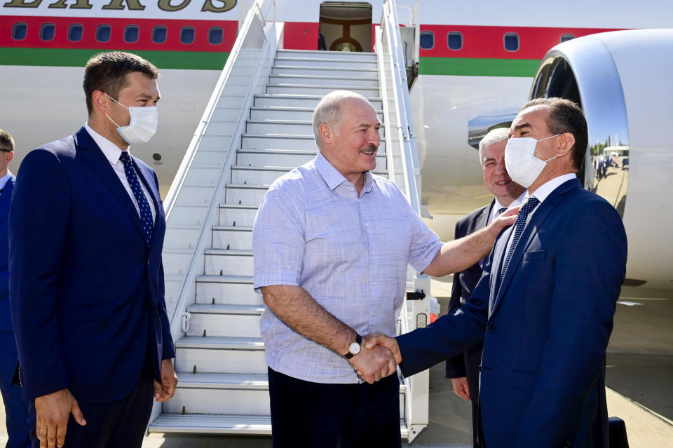 Belarusian President Alexander Lukashenko greets officials upon his arriving at the Black Sea resort of Sochi, Russia, Monday, Sept. 14, 2020. Belarus' authoritarian president, Lukashenko is visiting Sochi for talks with Russian President Vladimir Putin a day after an estimated 150,000 flooded the streets of the Belarusian capital, demanding Lukashenko's resignation. (Andrei Stasevich /BelTA Pool Photo via AP)