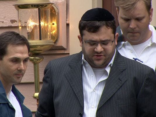 Eliyahu Weinstein is escorted by FBI agents in 2010.