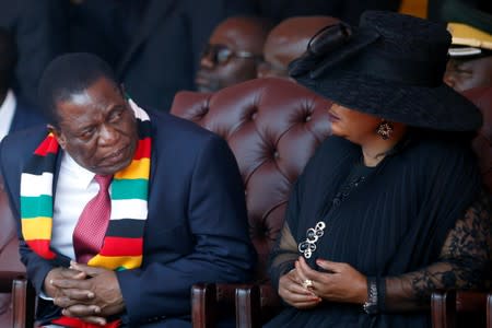 Zimbabwean President Mnangagwa looks on next to his wife Auxillia during the state funeral of Mugabe in Harare