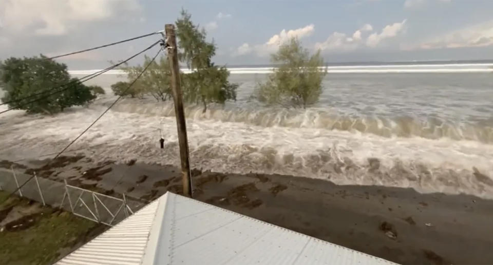 Water seen gushing over land from tsunami.