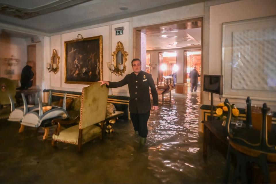 <div class="inline-image__caption"><p>A hotel worker navigates high water in the lobby of the flooded luxury Gritti Palace Hotel in central Venice several blocks from St. Mark’s Square. A combination of torrential winds and sirocco winds blowing northward contributed to the exceptional flooding that pushed waters far into the lagoon city.</p></div> <div class="inline-image__credit">Marco Bertorello/Getty</div>