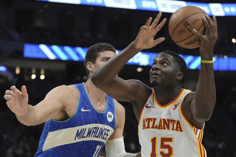 Atlanta Hawks' Clint Capela tries to shoot past Milwaukee Bucks' Brook Lopez during the first half of an NBA basketball game Saturday, Dec. 2, 2023, in Milwaukee. (AP Photo/Morry Gash)