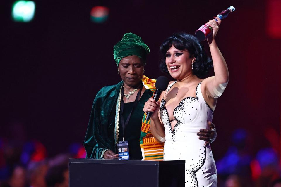 Raye on stage with her grandmother accepting the night’s top gong ‘Album of the Year’ (AFP via Getty Images)