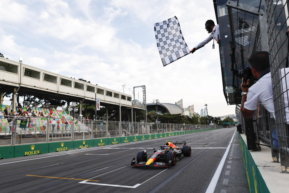 Red Bull driver Sergio Perez of Mexico crosses the finish line to set the second fastest time in the qualifying session at the Baku circuit, in Baku, Azerbaijan, Saturday, June 11, 2022. The Formula One Grand Prix will be held on Sunday. (Hamad Mohammed), Pool Via AP)