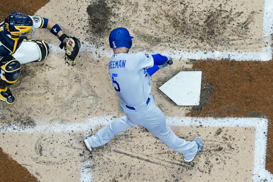 Los Angeles Dodgers' Freddie Freeman hits a single during the fourth inning of a baseball game against the Milwaukee Brewers Wednesday, Aug. 17, 2022, in Milwaukee. (AP Photo/Morry Gash)