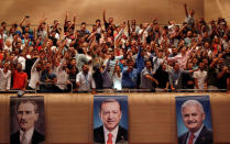 Supporters of Turkish President Tayyip Erdogan cheer as he speaks during a meeting of his ruling AK Party (AKP) in Istanbul, Turkey, August 20, 2017. REUTERS/Murad Sezer