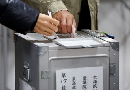 People cast votes for a national election at a polling station in Tokyo, Japan, October 22, 2017. REUTERS/Toru Hanai