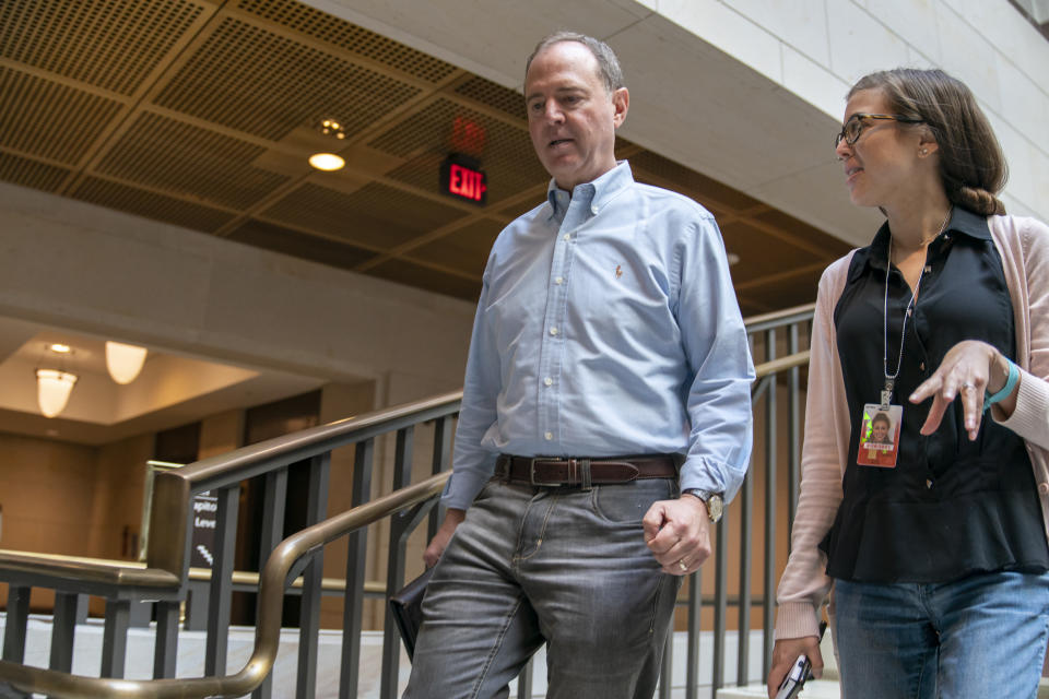 House Intelligence Committee Chairman Adam Schiff, D-Calif., joined by Communications Director Emilie Simons, walks to a secure facility in the Capitol to prepare for depositions in the impeachment inquiry of President Donald Trump. (AP Photo/J. Scott Applewhite)