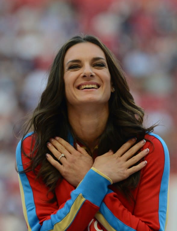 Russia's Yelena Isinbayeva smiling on the podium during the medal ceremony for the women's pole vault at the 2013 IAAF World Championships at the Luzhniki stadium in Moscow on August 15, 2013