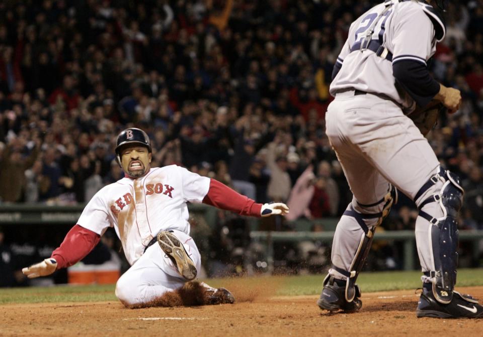 Dave Roberts slides home to score the tying run against the New York Yankees in Game 4 of the 2004 ALCS.
