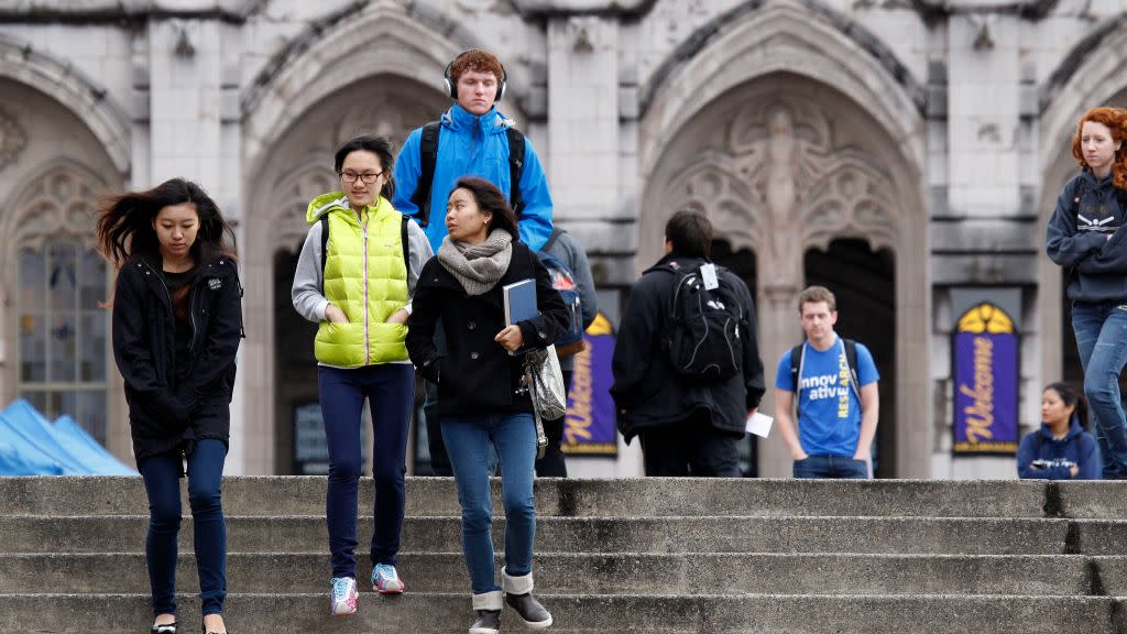 People walk down stairs on a campus