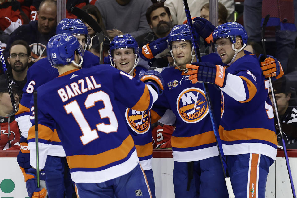 New York Islanders right wing Oliver Wahlstrom, second right, is congratulated by teammates after his goal against the New Jersey Devils during the second period of an NHL hockey game Friday, Dec. 9, 2022, in Newark, N.J. (AP Photo/Adam Hunger)