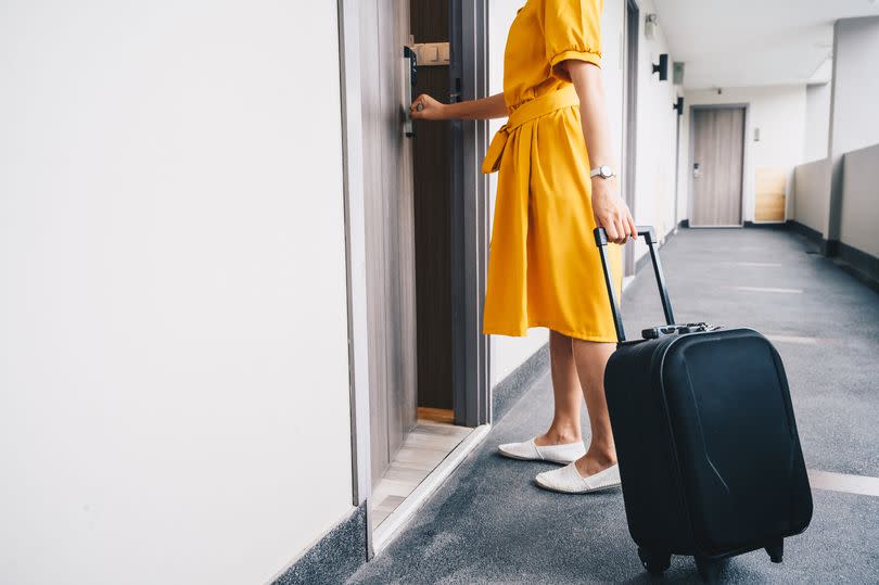 Woman checking into hotel room